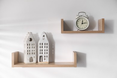 Photo of Wooden shelves with decor on white background