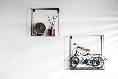 Photo of Metal shelves with stylish decor on white background