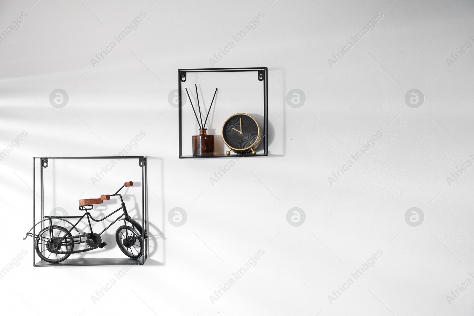 Metal shelves with stylish decor on white background Photo of Metal shelves with stylish decor on white background