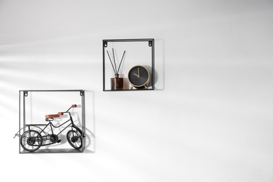 Photo of Metal shelves with stylish decor on white background