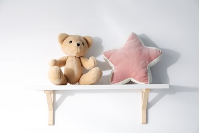 Photo of Shelf with soft toys on white background