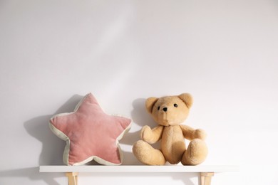 Photo of Shelf with soft toys on white background. Space for text