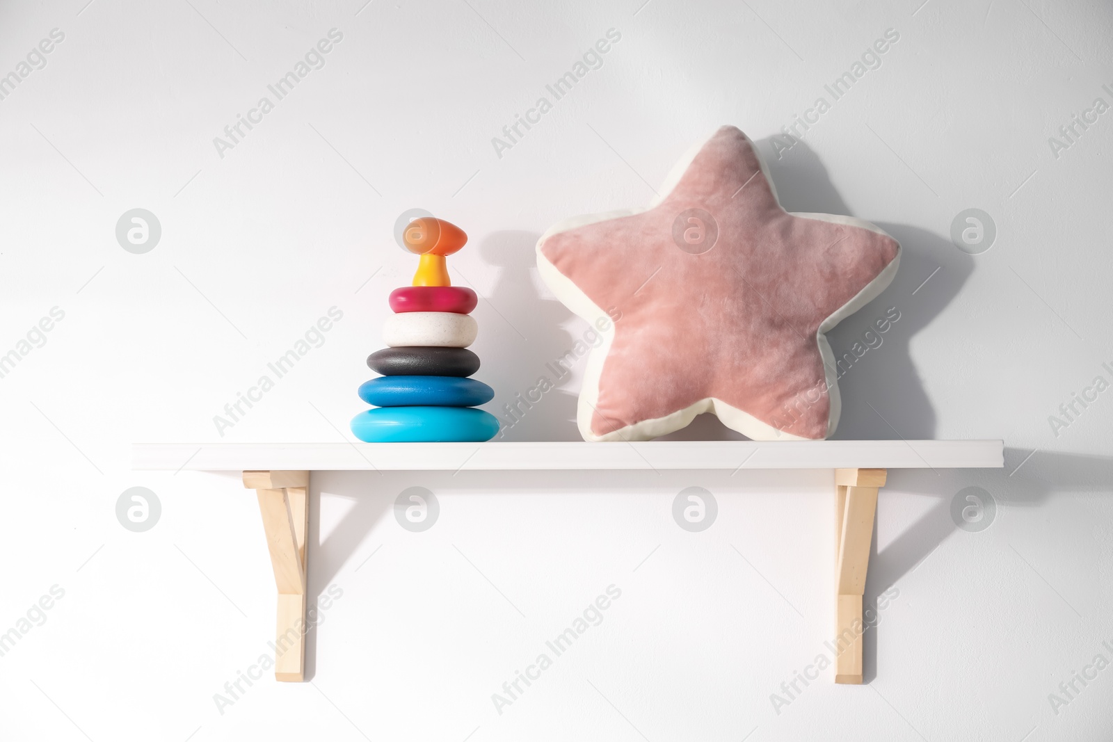 Shelf with different toys on white background Photo of Shelf with different toys on white background