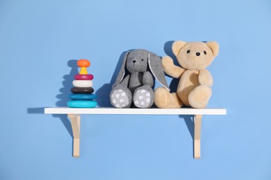 Photo of Shelf with different toys on blue background