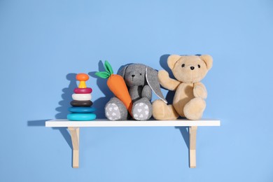 Photo of Shelf with different toys on blue background