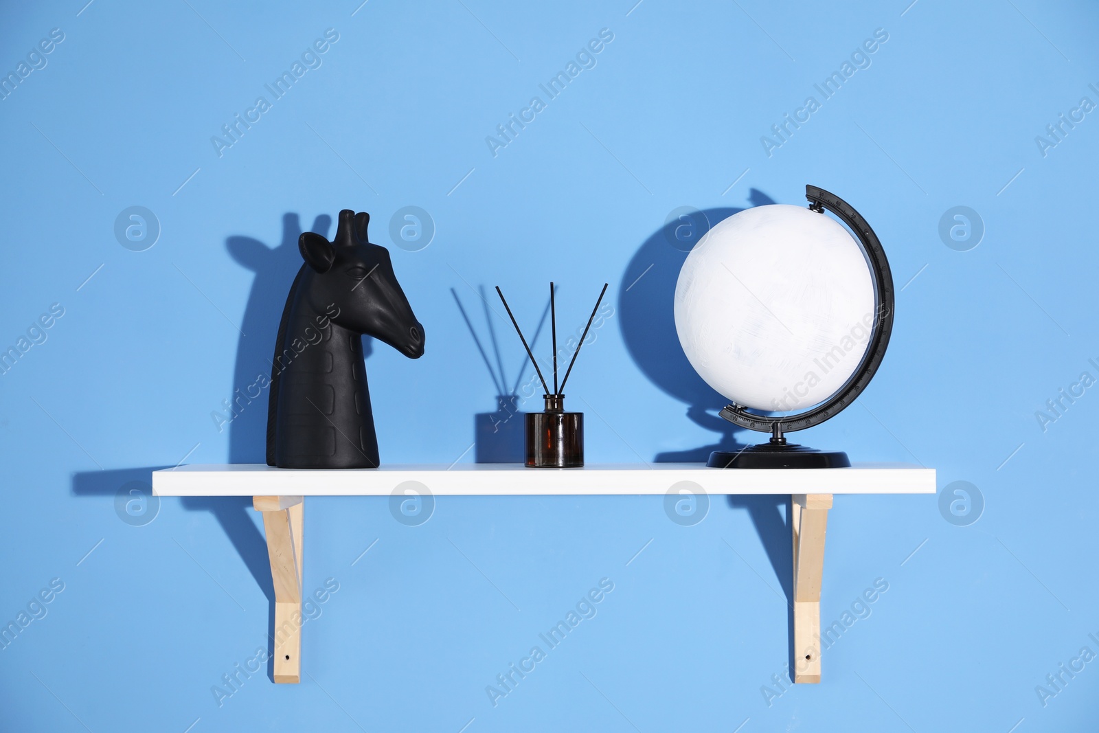 Photo of Shelf with stylish decor on blue background