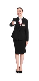 Photo of Smiling receptionist in uniform giving hotel key card on white background
