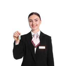 Photo of Smiling receptionist in uniform with guest room key on white background