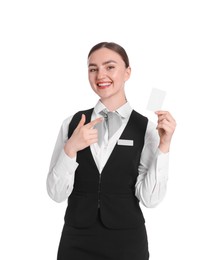 Photo of Smiling receptionist in uniform pointing at hotel key card on white background