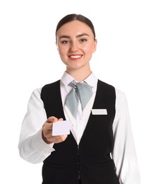 Photo of Smiling receptionist in uniform giving hotel key card on white background