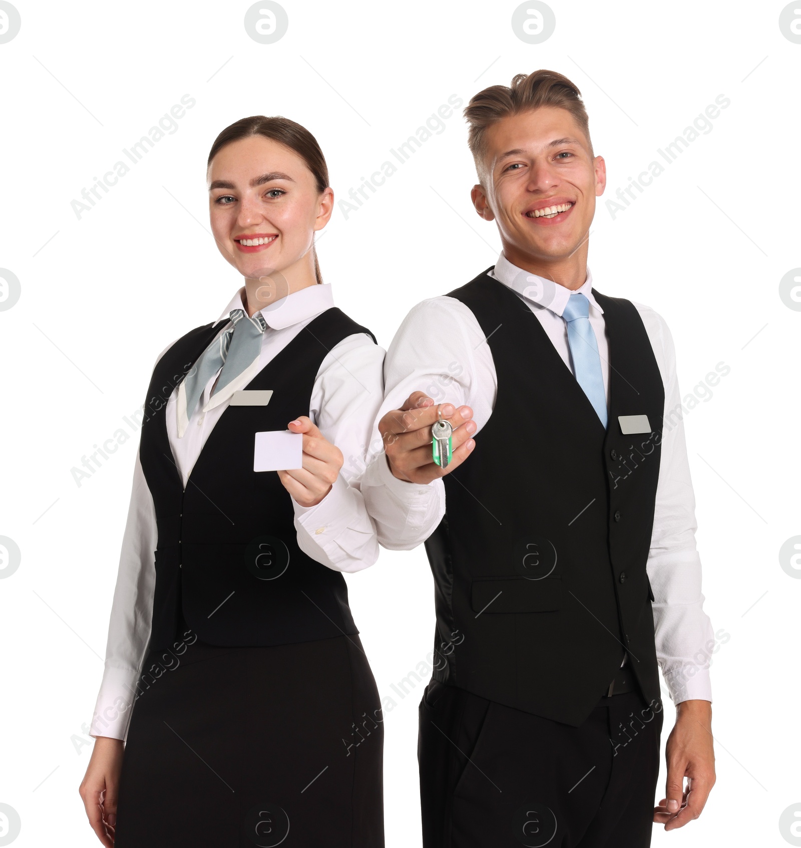 Smiling receptionists in uniforms with guest room keys on white background Photo of Smiling receptionists in uniforms with guest room keys on white background