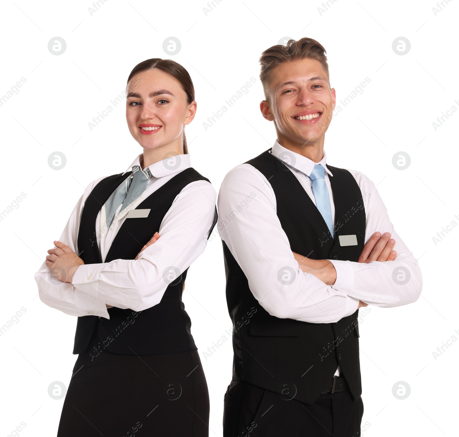 Smiling receptionists in uniforms with crossed arms on white background Photo of Smiling receptionists in uniforms with crossed arms on white background