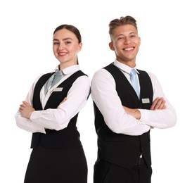 Photo of Smiling receptionists in uniforms with crossed arms on white background