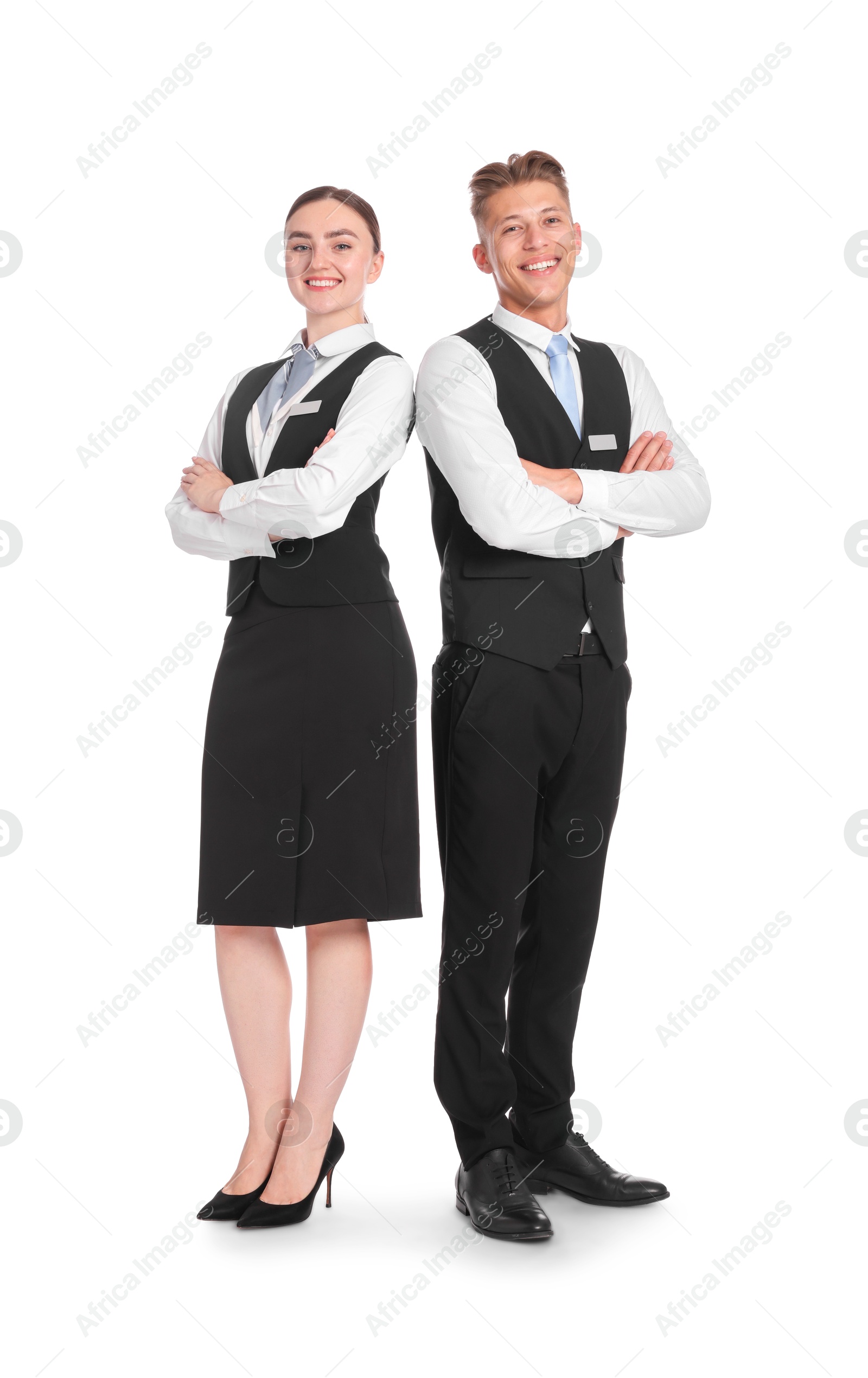 Smiling receptionists in uniforms with crossed arms on white background Photo of Smiling receptionists in uniforms with crossed arms on white background