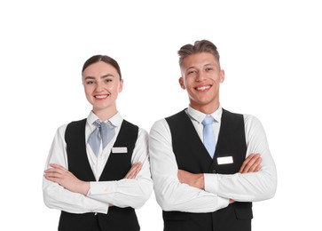 Photo of Smiling receptionists in uniforms with crossed arms on white background