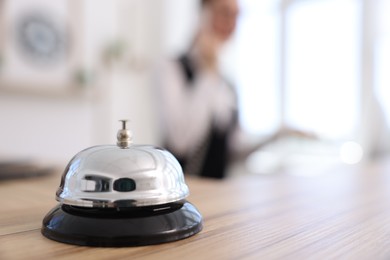 Photo of Receptionist working in hotel, focus on service bell