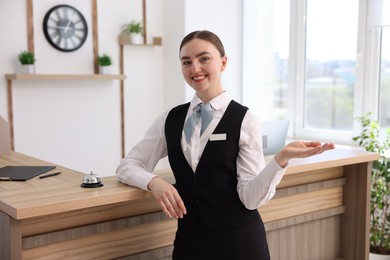 Photo of Portrait of smiling receptionist welcoming in hotel