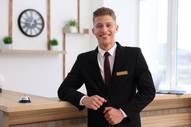 Photo of Portrait of smiling receptionist in uniform in hotel