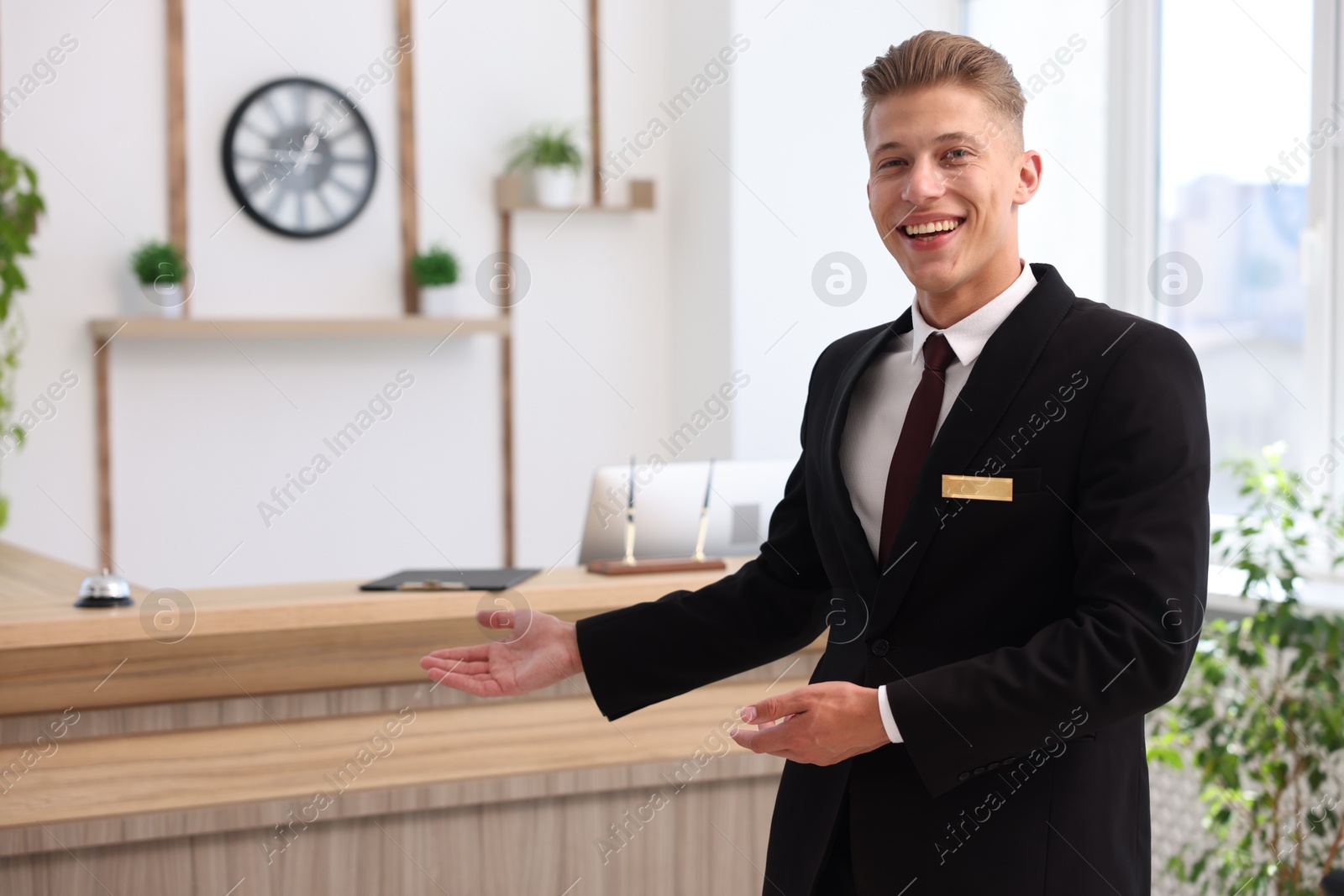 Portrait of smiling receptionist welcoming in hotel Photo of Portrait of smiling receptionist welcoming in hotel