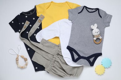 Photo of Baby clothes and accessories on white background, flat lay