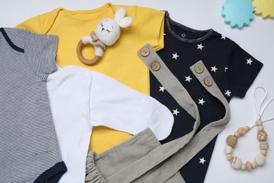 Photo of Baby clothes and accessories on white background, flat lay