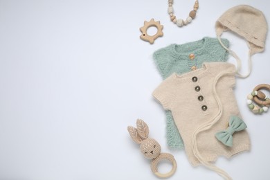 Photo of Baby clothes and accessories on white background, flat lay. Space for text