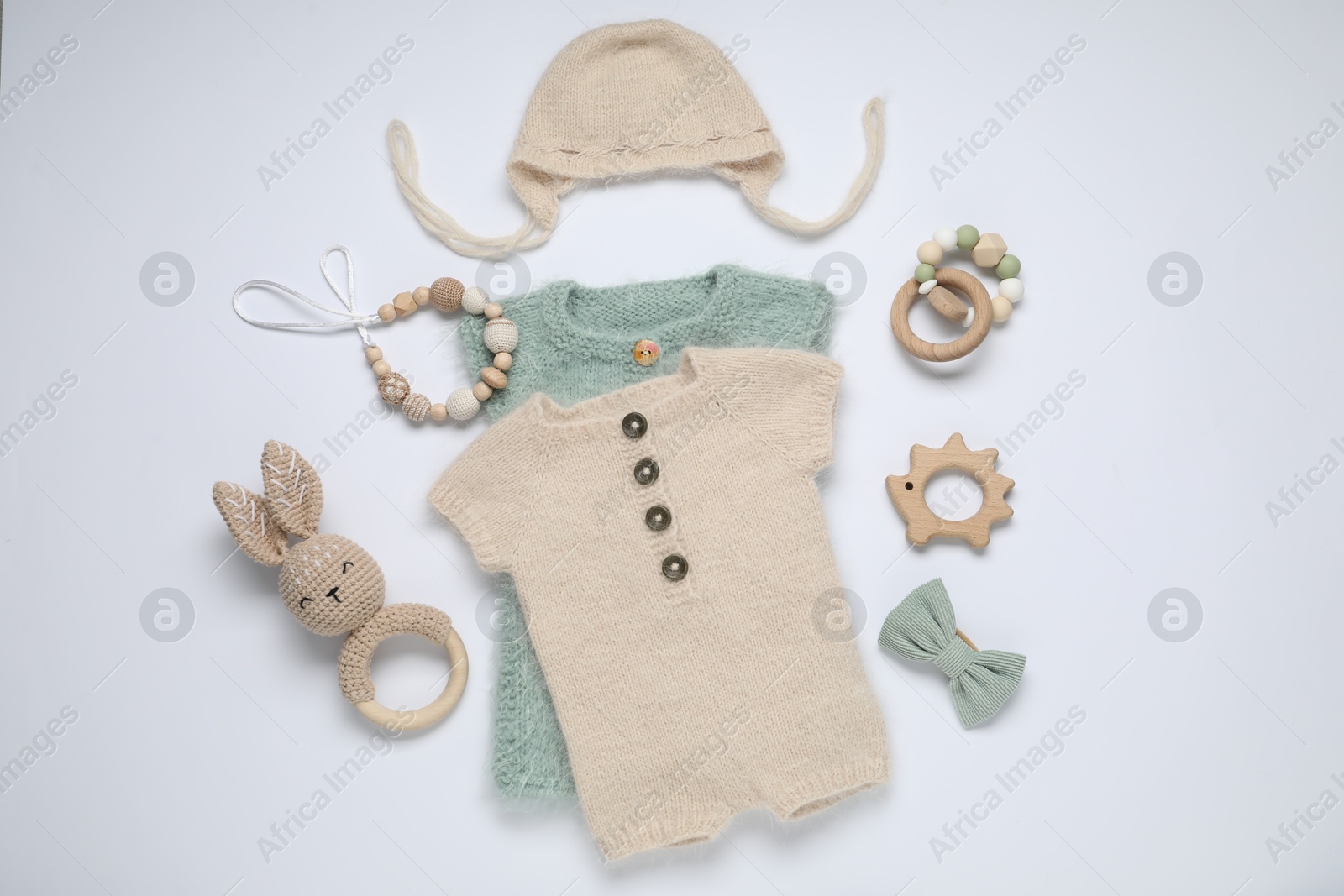 Baby clothes and accessories on white background, flat lay Photo of Baby clothes and accessories on white background, flat lay