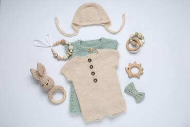 Photo of Baby clothes and accessories on white background, flat lay
