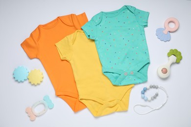 Photo of Baby clothes and accessories on white background, flat lay