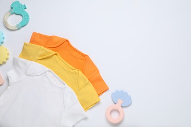 Photo of Baby clothes and accessories on white background, flat lay. Space for text