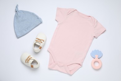 Photo of Baby clothes and accessories on white background, flat lay