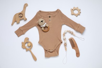 Photo of Baby onesie and accessories on white background, flat lay