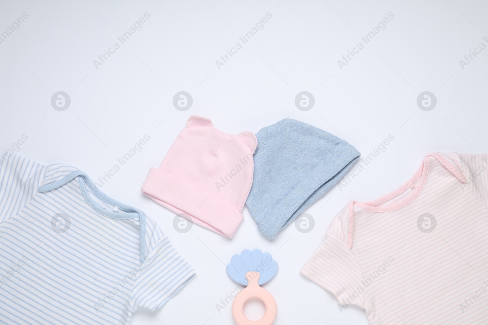 Photo of Baby clothes and accessory on white background, flat lay. Space for text
