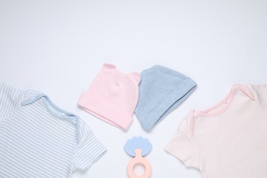 Photo of Baby clothes and accessory on white background, flat lay. Space for text