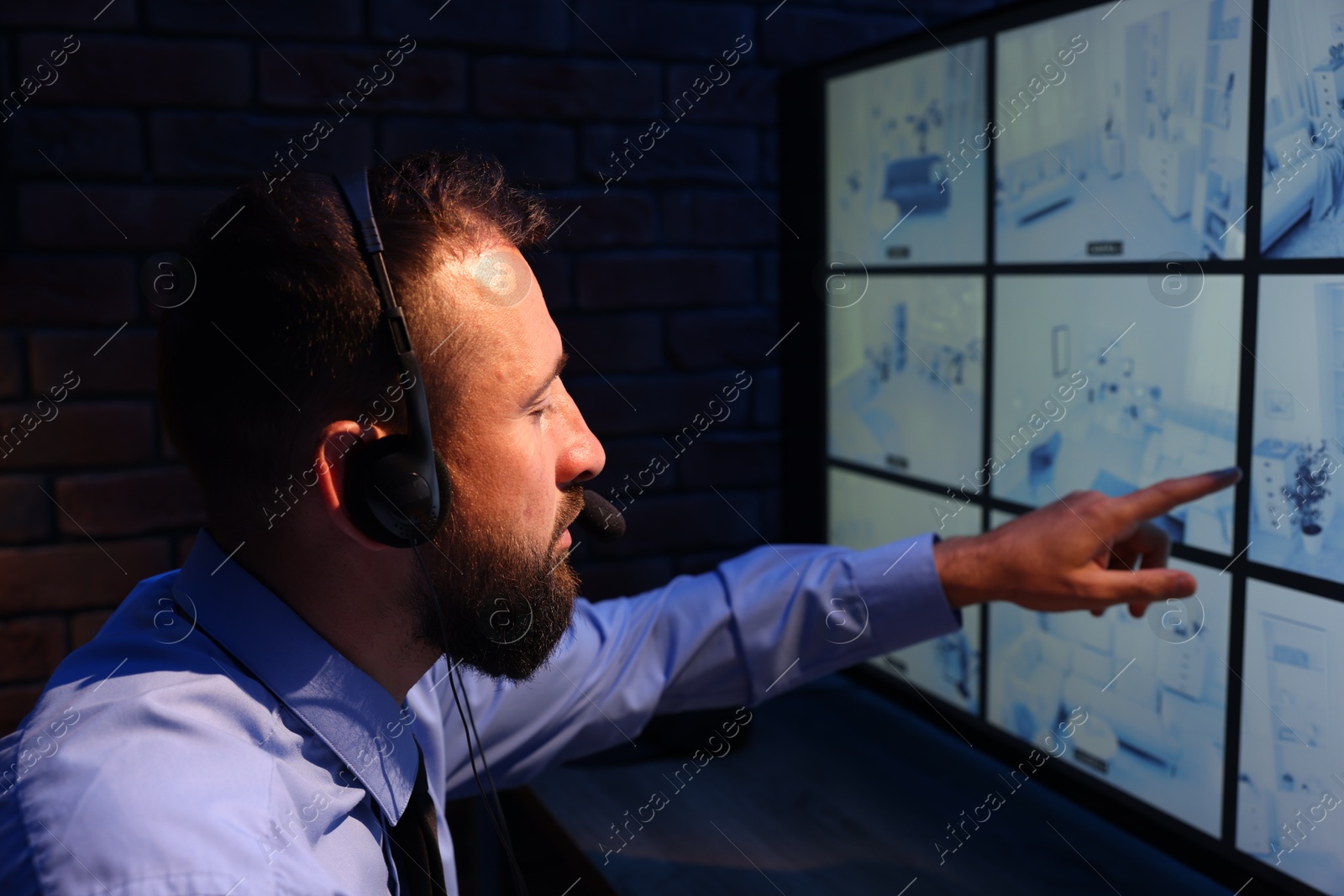 Security guard monitoring CCTV cameras in office at night Photo of Security guard monitoring CCTV cameras in office at night