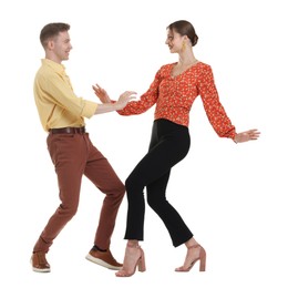 Photo of Happy couple in retro outfits dancing on white background