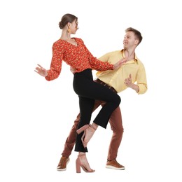 Photo of Happy couple in retro outfits dancing on white background