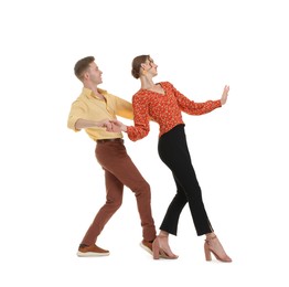 Photo of Happy couple in retro outfits dancing on white background