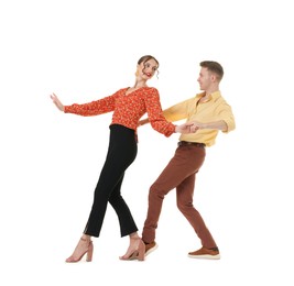 Photo of Happy couple in retro outfits dancing on white background
