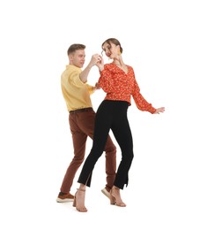 Photo of Happy couple in retro outfits dancing on white background