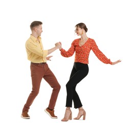 Photo of Happy couple in retro outfits dancing on white background