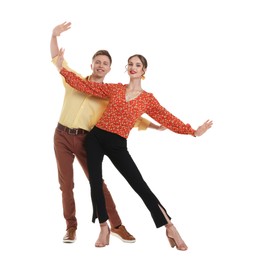Photo of Happy couple in retro outfits dancing on white background