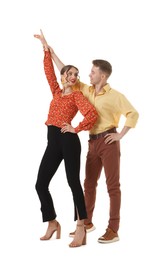 Photo of Happy couple in retro outfits dancing on white background