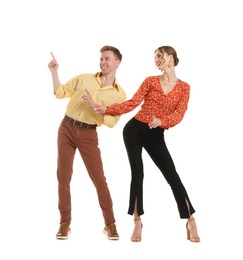 Photo of Happy couple in retro outfits dancing on white background