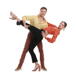 Photo of Happy couple in retro outfits dancing on white background