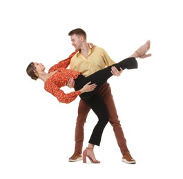 Photo of Happy couple in retro outfits dancing on white background