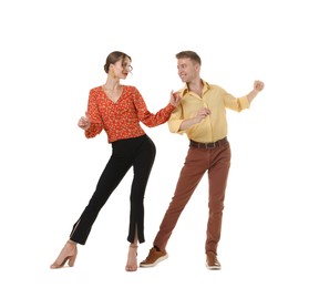Photo of Happy couple in retro outfits dancing on white background