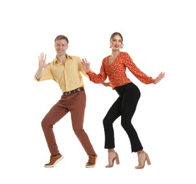 Photo of Happy couple in retro outfits dancing on white background