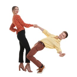 Photo of Happy couple in retro outfits dancing on white background