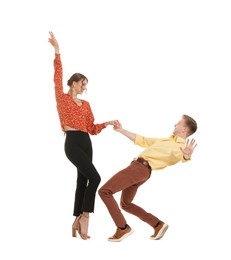 Photo of Happy couple in retro outfits dancing on white background